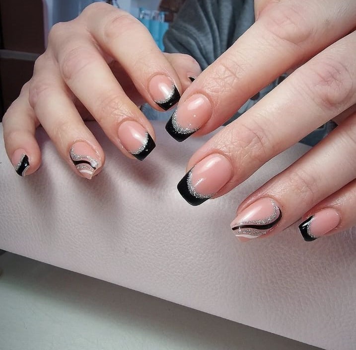 Classic black tip French nails with a twist