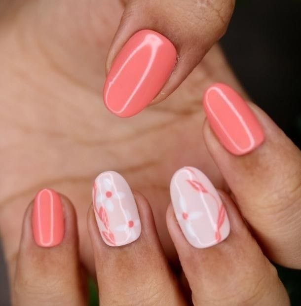 Coral Nails with White Floral Blooms