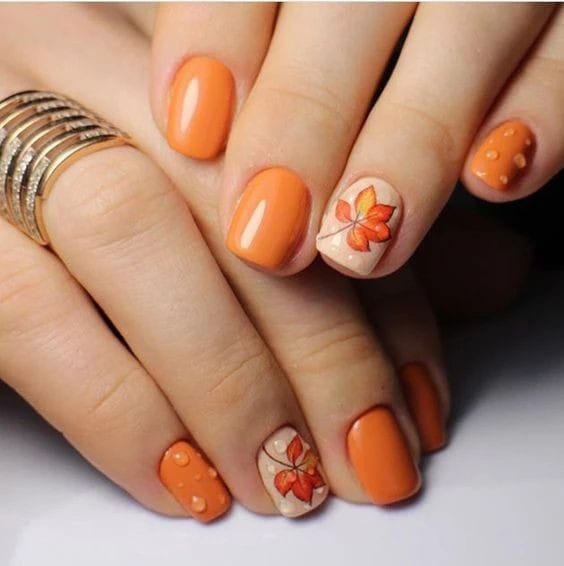 burnt orange shorties with leafy detail nails