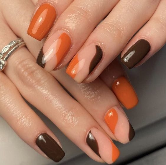 negative space fusion of orange and brown nails